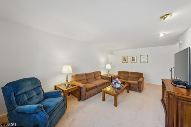 living area featuring light carpet