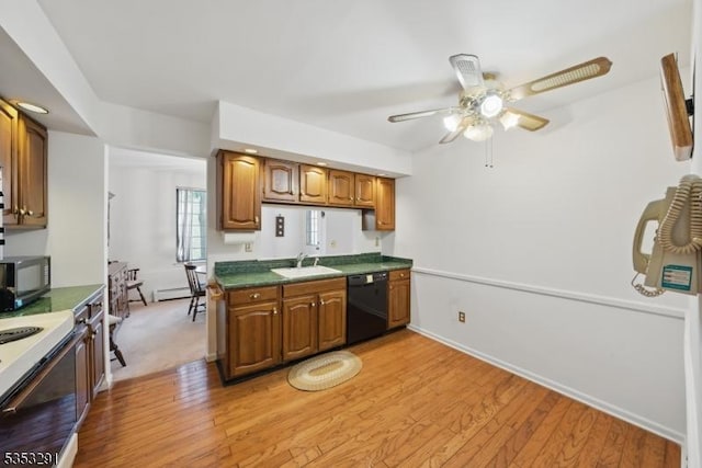 kitchen featuring stove, stainless steel microwave, black dishwasher, ceiling fan, and a sink