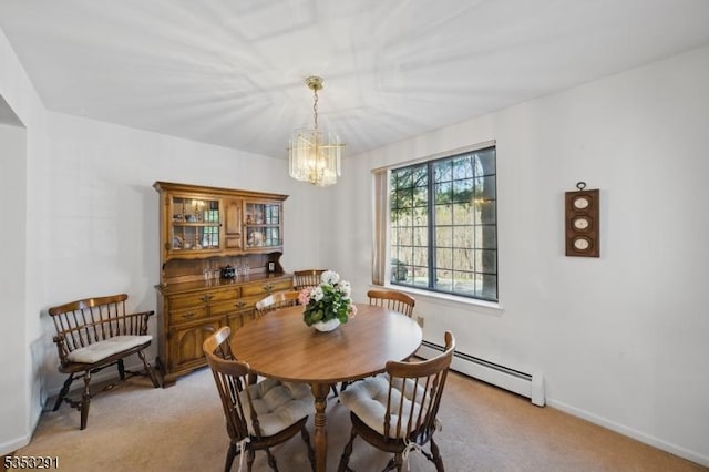 dining area featuring baseboards, a notable chandelier, baseboard heating, and light carpet