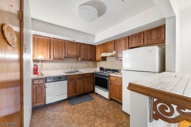 1250 N Broad St Unit A1, Hillside Twp, NJ 07205 - kitchen with white appliances, under cabinet range hood, brown cabinetry, and a sink