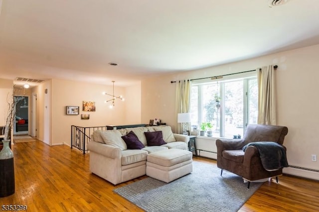 1231 Sunnyfield Ln, Scotch Plains Twp, NJ 07076 - living room featuring baseboard heating, wood finished floors, and a chandelier