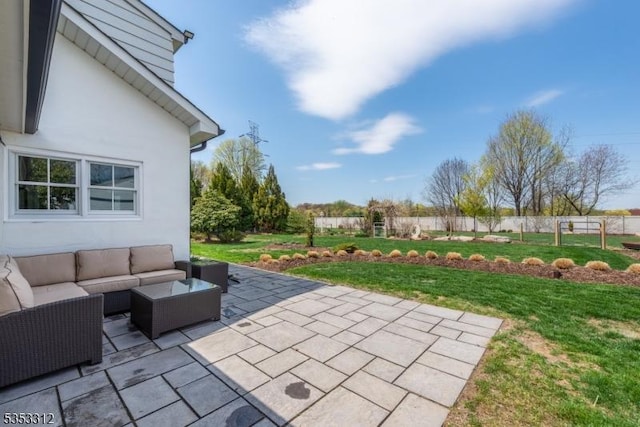 view of patio with an outdoor living space and fence