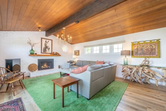 living room with lofted ceiling with beams, an inviting chandelier, wood finished floors, wood ceiling, and a brick fireplace