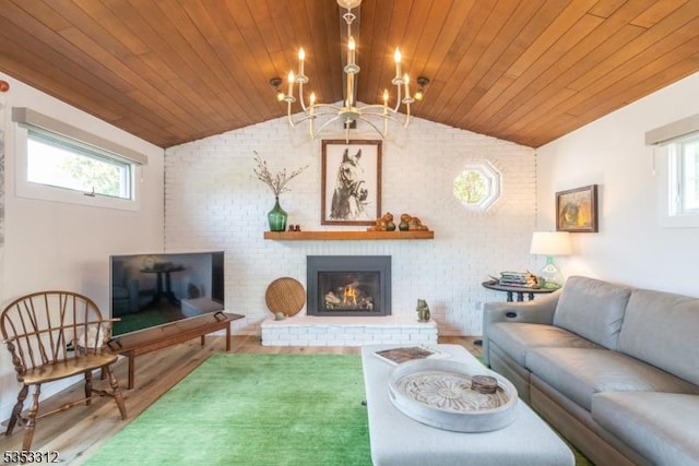 living area featuring wooden ceiling, a chandelier, a fireplace, lofted ceiling, and wood finished floors