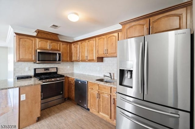 452 Fulton St, Elizabeth City, NJ 07206 - kitchen featuring appliances with stainless steel finishes, a sink, crown molding, light stone counters, and tasteful backsplash