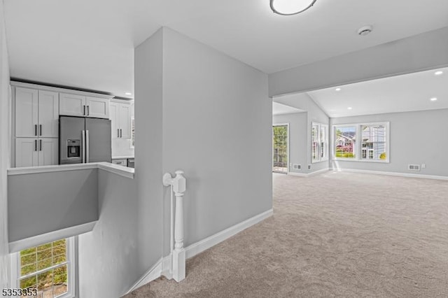interior space with baseboards, an upstairs landing, carpet, and recessed lighting