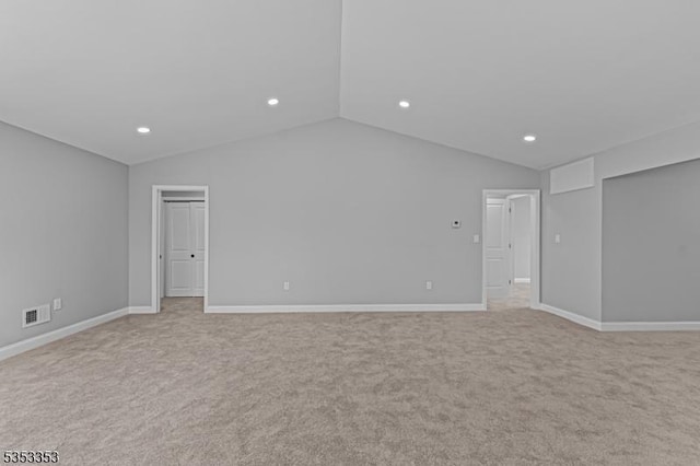 spare room with lofted ceiling, light carpet, recessed lighting, and baseboards