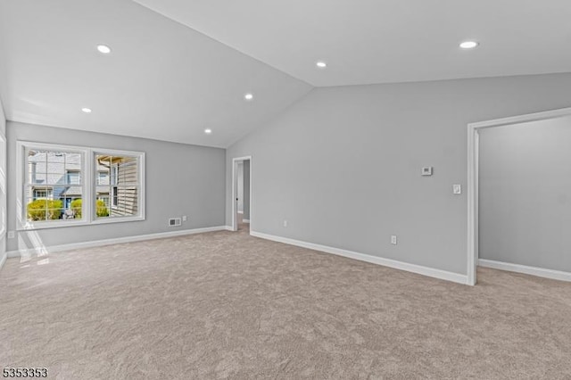 unfurnished living room with carpet flooring, recessed lighting, lofted ceiling, and baseboards