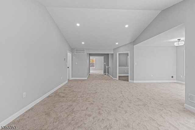 carpeted spare room featuring lofted ceiling, baseboards, and recessed lighting