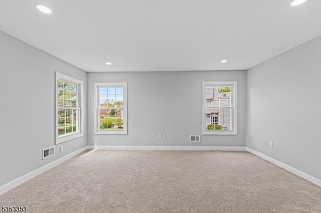 carpeted empty room with recessed lighting and baseboards