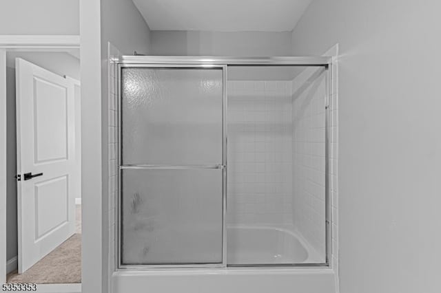 bathroom featuring shower / bath combination with glass door
