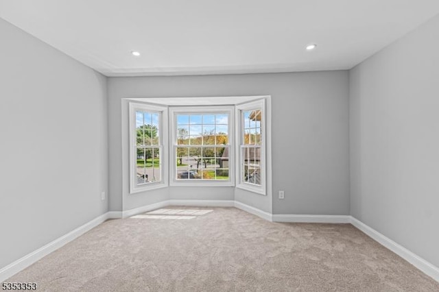 unfurnished room featuring carpet flooring, baseboards, and recessed lighting
