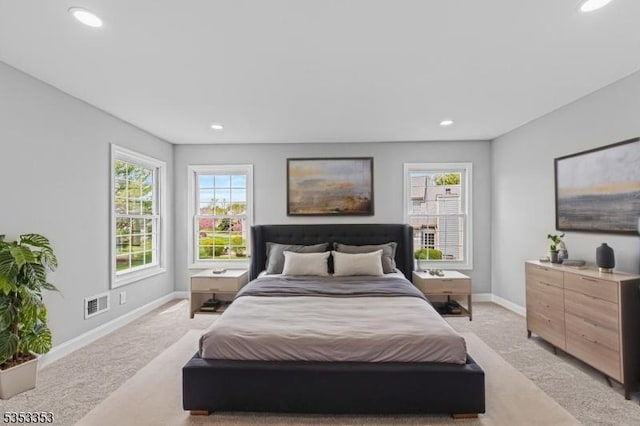 bedroom featuring light carpet, baseboards, recessed lighting, and multiple windows