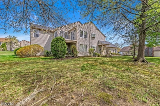 rear view of property with a lawn