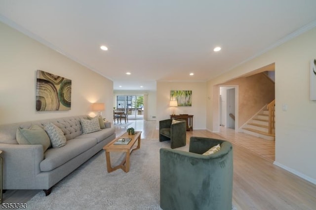 living room with ornamental molding, baseboards, stairway, recessed lighting, and light wood finished floors