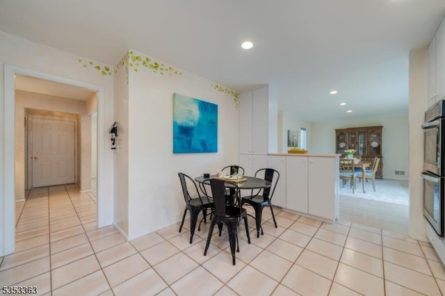 dining room with recessed lighting and light tile patterned floors
