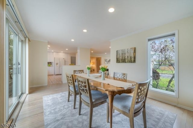 dining room with baseboards, ornamental molding, light wood-type flooring, and recessed lighting