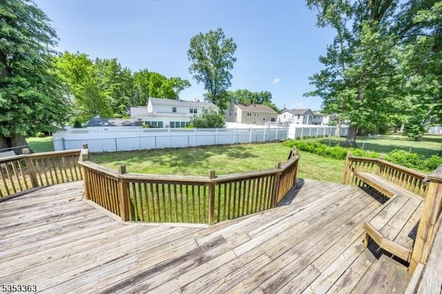 deck featuring a lawn and a fenced backyard