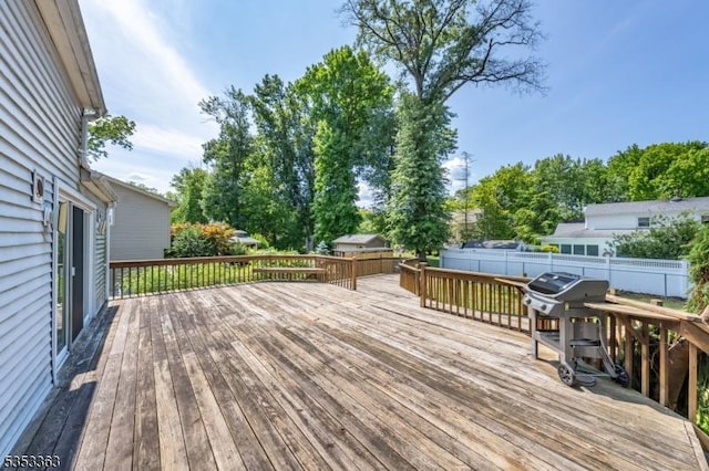 wooden terrace featuring fence
