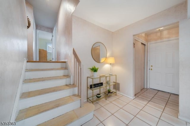 stairs with tile patterned flooring