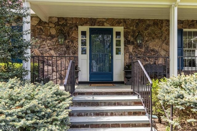property entrance featuring a porch and stone siding