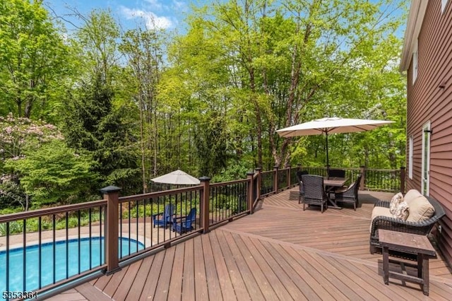 deck with a fenced in pool and outdoor dining space