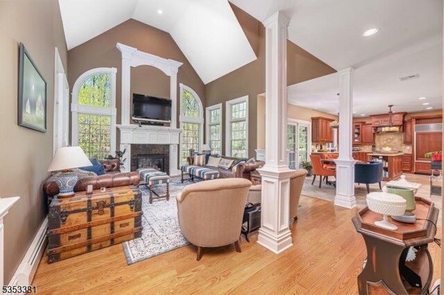 14 Jenny Ln, Vernon Twp, NJ 07461 - living area featuring a healthy amount of sunlight, baseboard heating, decorative columns, and light wood finished floors