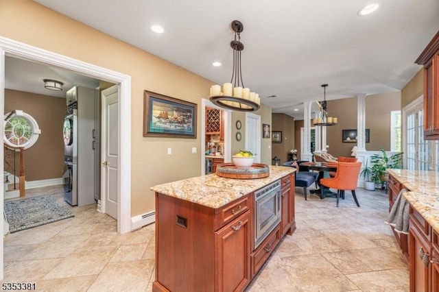 14 Jenny Ln, Vernon Twp, NJ 07461 - kitchen featuring stacked washer and dryer, pendant lighting, light stone countertops, stainless steel microwave, and a baseboard heating unit