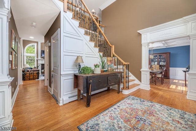 14 Jenny Ln, Vernon Twp, NJ 07461 - interior space with ornamental molding, stairs, decorative columns, a decorative wall, and light wood finished floors