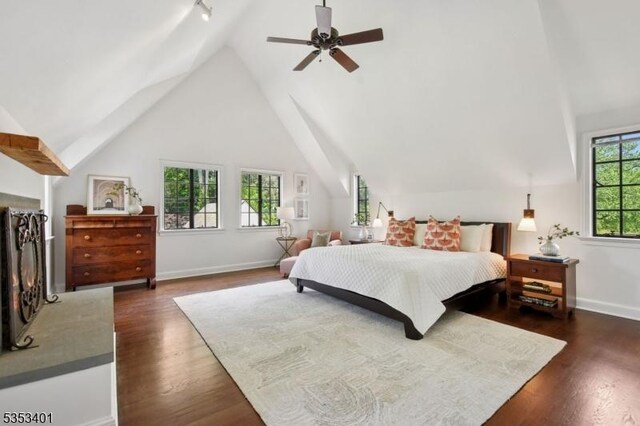 bedroom with dark wood-style flooring, high vaulted ceiling, baseboards, and a ceiling fan