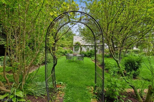 view of yard with an outdoor fire pit and a gate