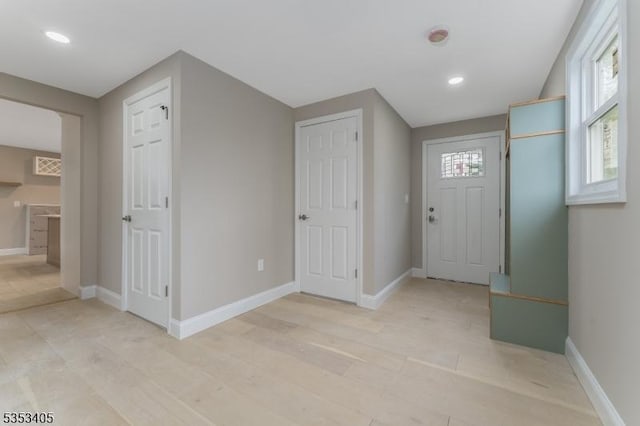 entryway featuring recessed lighting, light wood-style floors, and baseboards