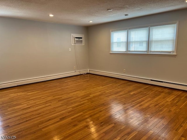 28 W Elizabeth Ave Unit B3, Linden City, NJ 07036 - empty room featuring recessed lighting, a textured ceiling, a wall unit AC, and hardwood / wood-style flooring