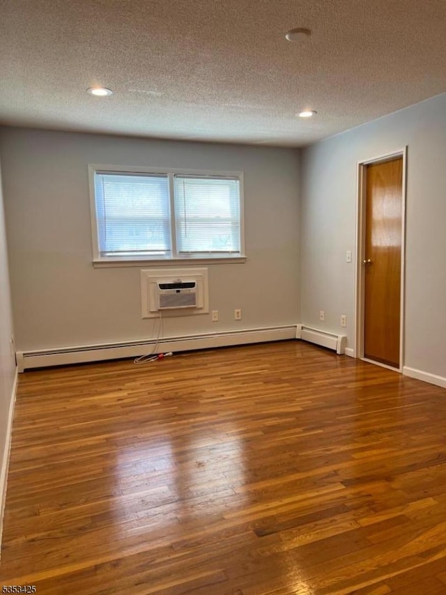 28 W Elizabeth Ave Unit B3, Linden City, NJ 07036 - spare room with a wall mounted AC, recessed lighting, a textured ceiling, and wood finished floors