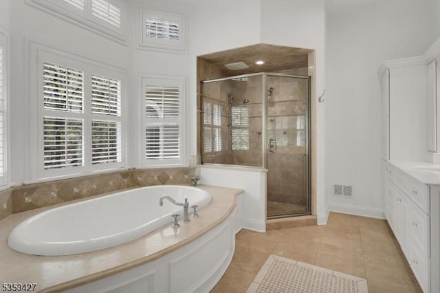 full bath featuring vanity, tile patterned floors, a shower stall, visible vents, and a bath