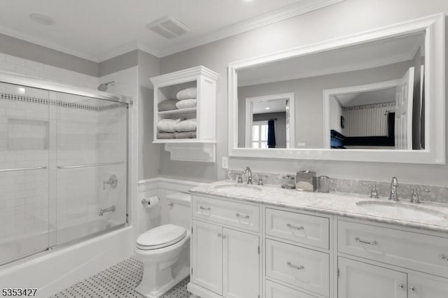 full bath with a sink, toilet, double vanity, and visible vents