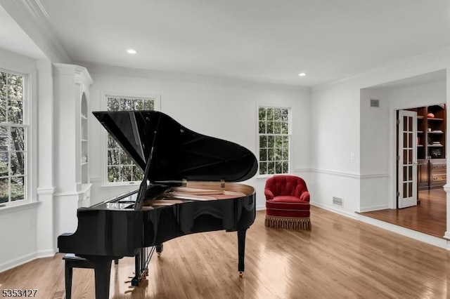 sitting room with decorative columns, recessed lighting, wood finished floors, and visible vents