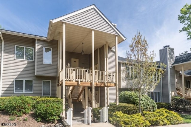 exterior space with stairway, a chimney, and central AC unit
