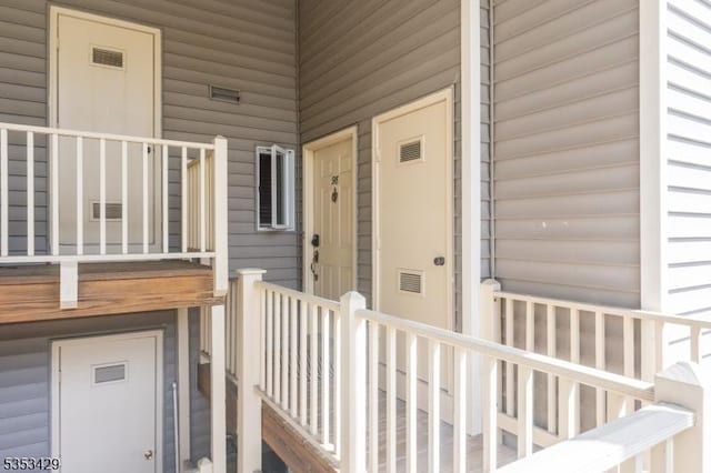 property entrance with visible vents and a balcony