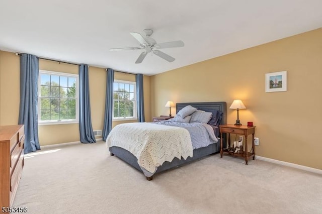 bedroom featuring baseboards, ceiling fan, and light colored carpet