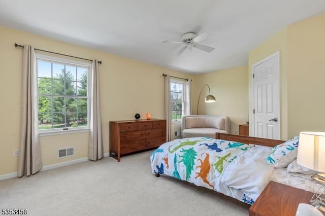 bedroom featuring visible vents, carpet flooring, baseboards, and ceiling fan