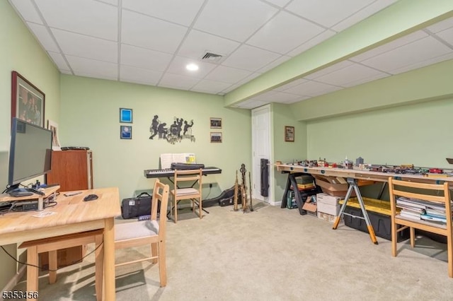 carpeted home office featuring a workshop area, a paneled ceiling, and visible vents