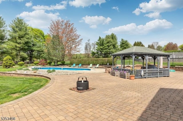 exterior space featuring fence, a pool, a gazebo, and a patio