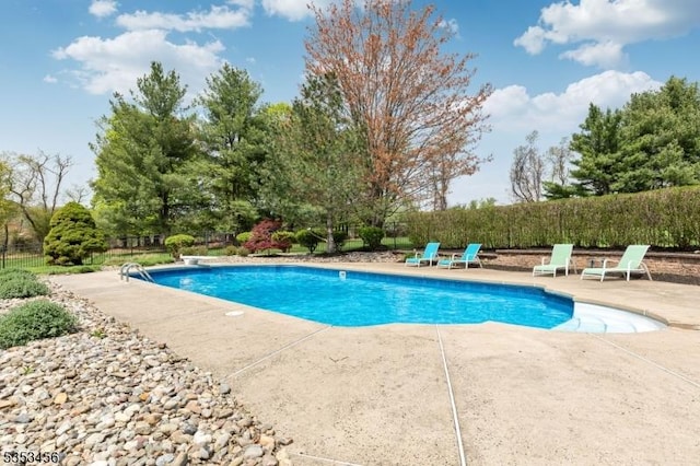 view of swimming pool with a fenced in pool, fence, and a patio