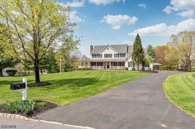 view of front of house with a porch and a front yard