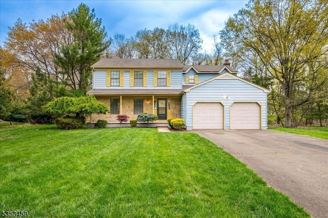 view of front of house with a front lawn, a chimney, an attached garage, driveway, and a porch