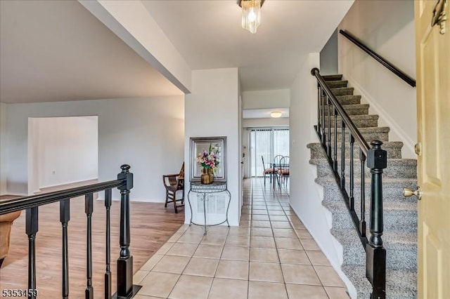 foyer featuring stairway and light tile patterned flooring