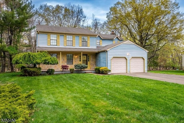 view of front of home with a front lawn, a garage, a porch, a chimney, and driveway