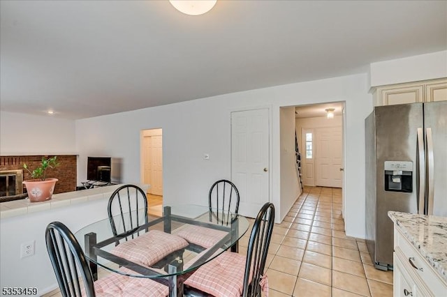 dining area with baseboards and light tile patterned floors