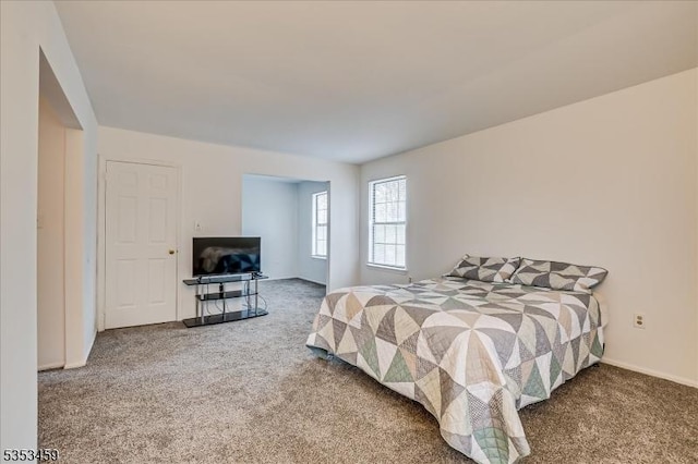 carpeted bedroom with baseboards